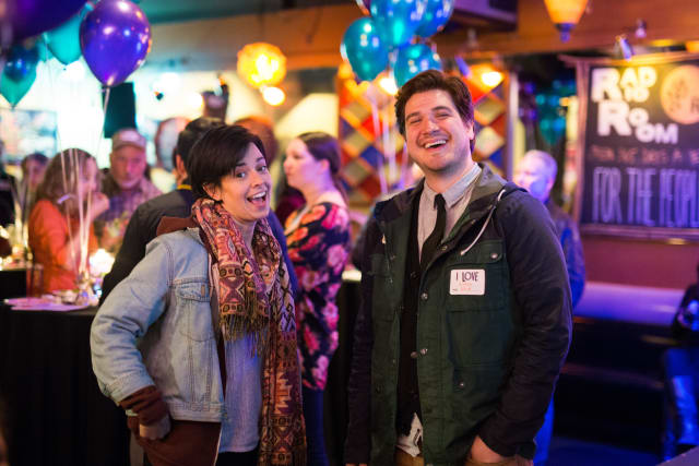 Smiling attendees at the Love Bomb 2017 event, surrounded by colorful balloons and a festive atmosphere, celebrating community support for My Voice Music.